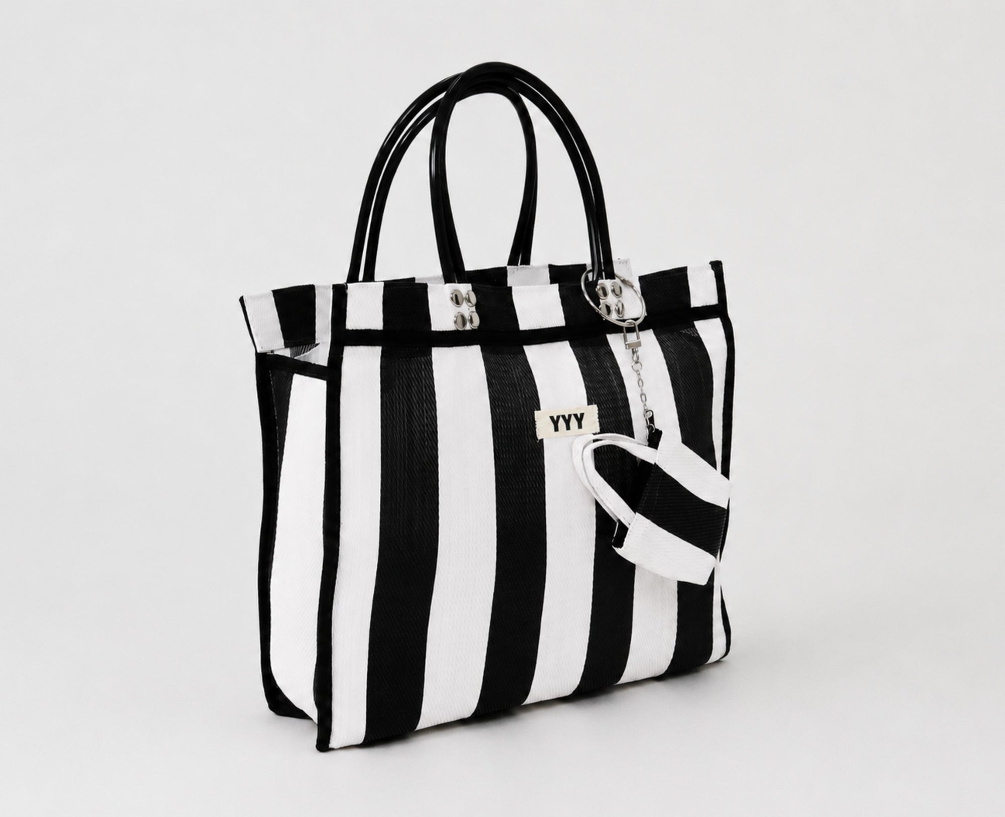 Side view of The Tote black and white striped recycled plastic bag