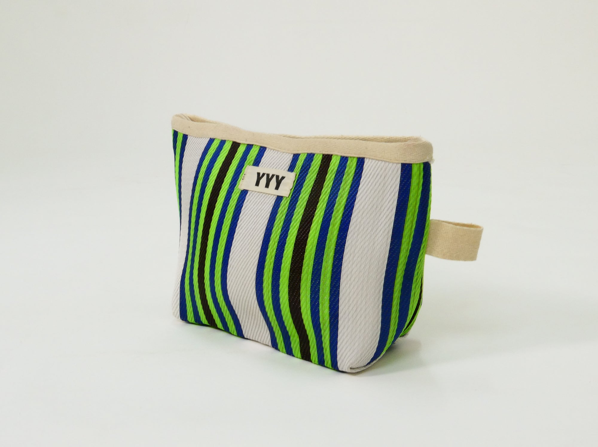 The Clutch Bag in green, black, and white stripes made from 100% recycled plastic