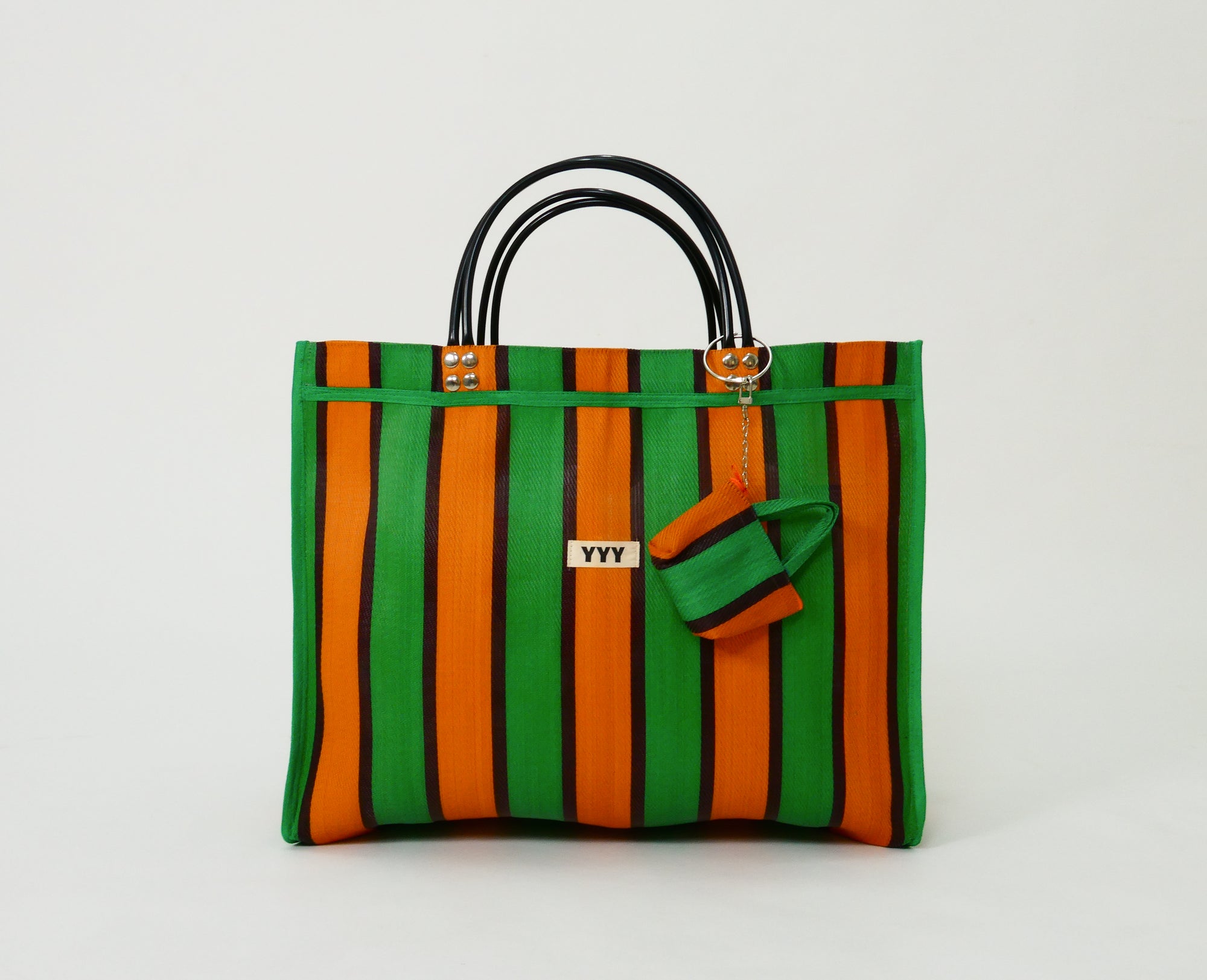 The Huge handmade tote bag in orange and green stripes is made from 100% recycled plastic