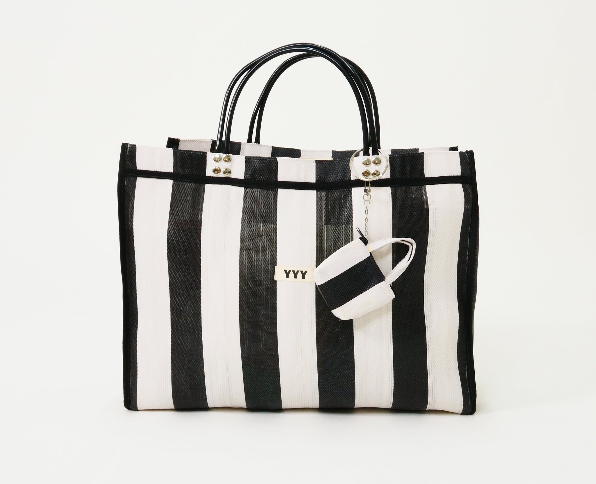 Black and white striped tote bag with a matching mini wallet. 