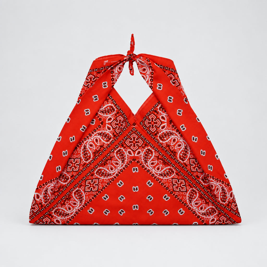 A orange halter-style bag made from cotton printed paisley bandana 