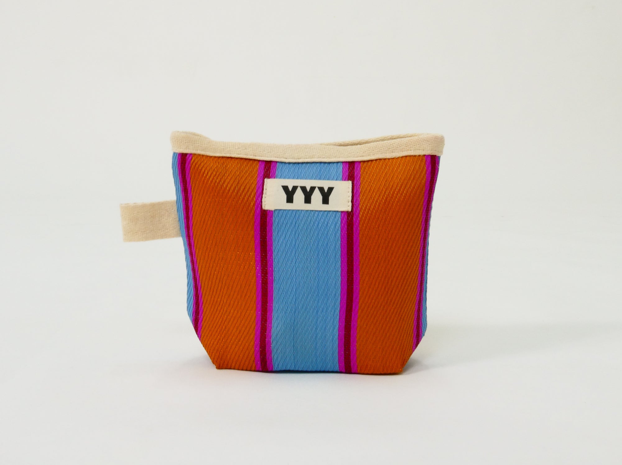 The Mini pouch in orange, blue, and pink stripes made from recycled plastic
