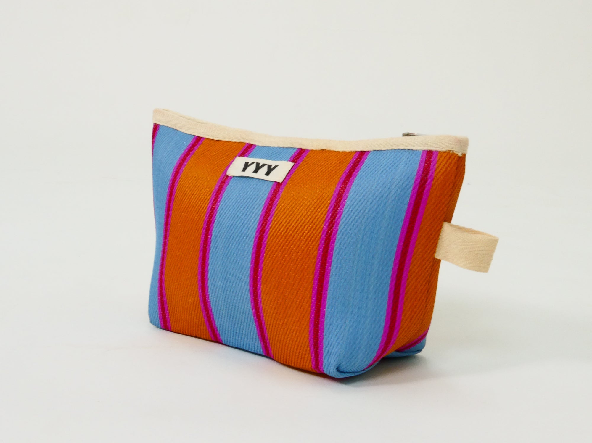 Handmade craftsmanship detail on striped clutch bag
