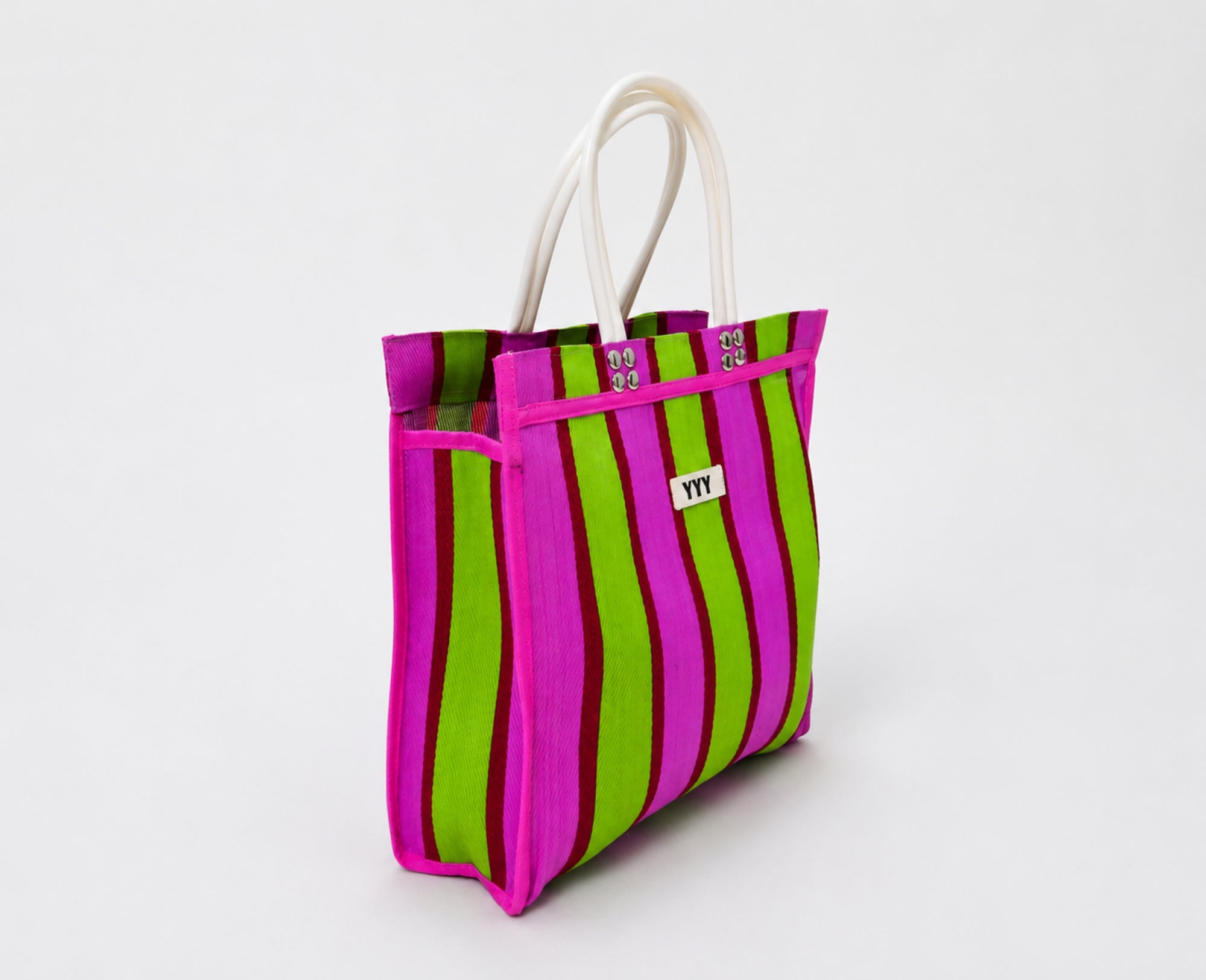 Vibrant striped tote bag handmade from recycled plastic. A durable everyday bag designed for work, shopping, and travel.