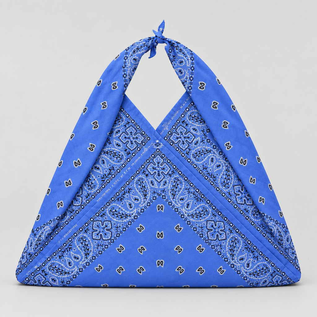 A blue bandana-style bag with a paisley pattern, tied at the top.