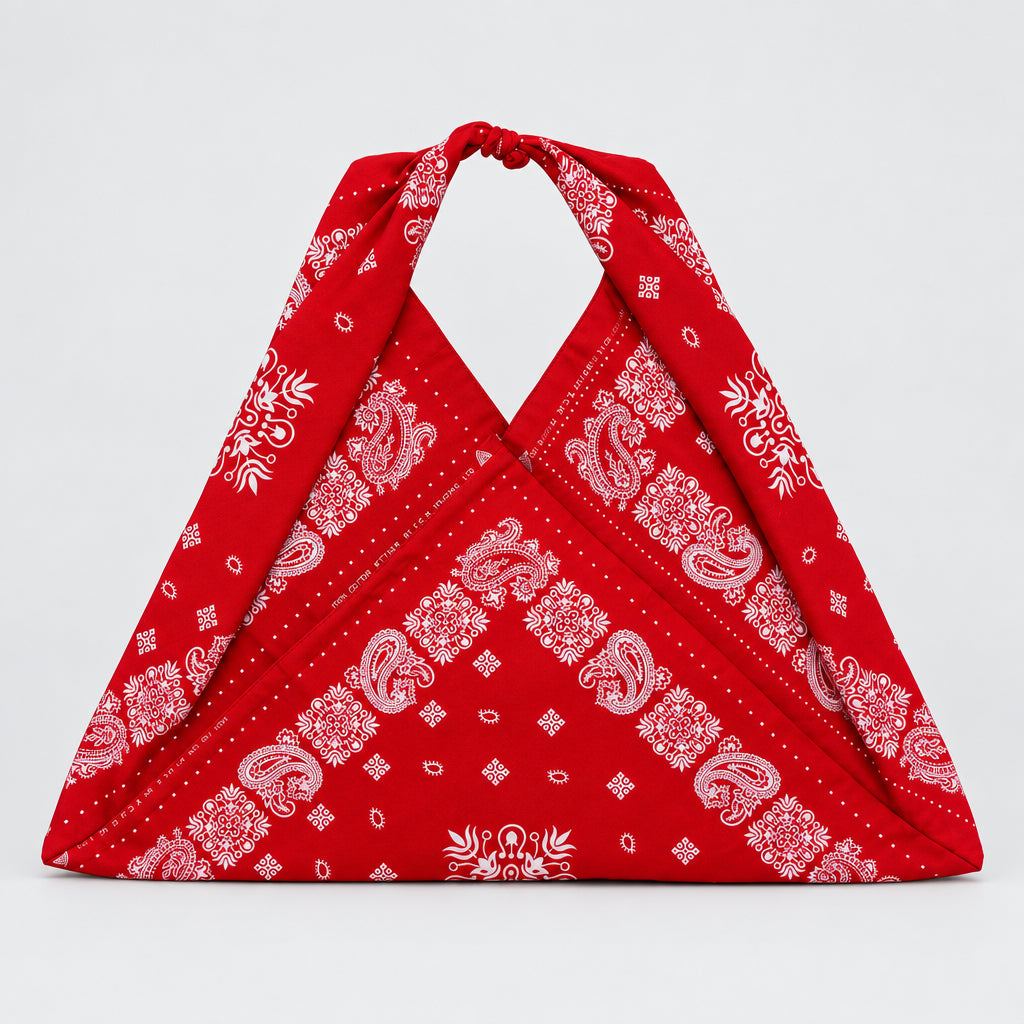 A red bandana-style shoulder bag with white paisley and floral patterns